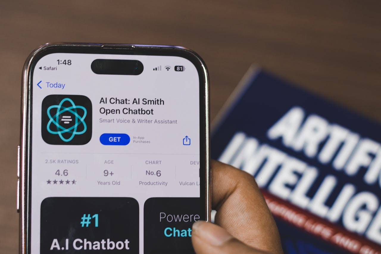 Services-03 Hand holding a smartphone with AI chatbot app, emphasizing artificial intelligence and technology.